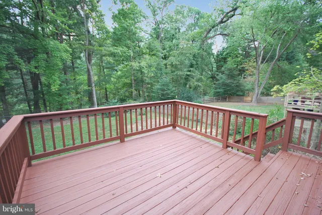 a view of balcony with wooden floor and fence
