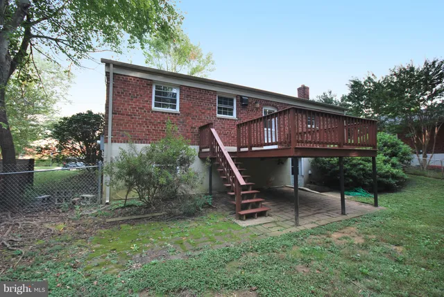 a view of a house with backyard wooden deck and sitting area