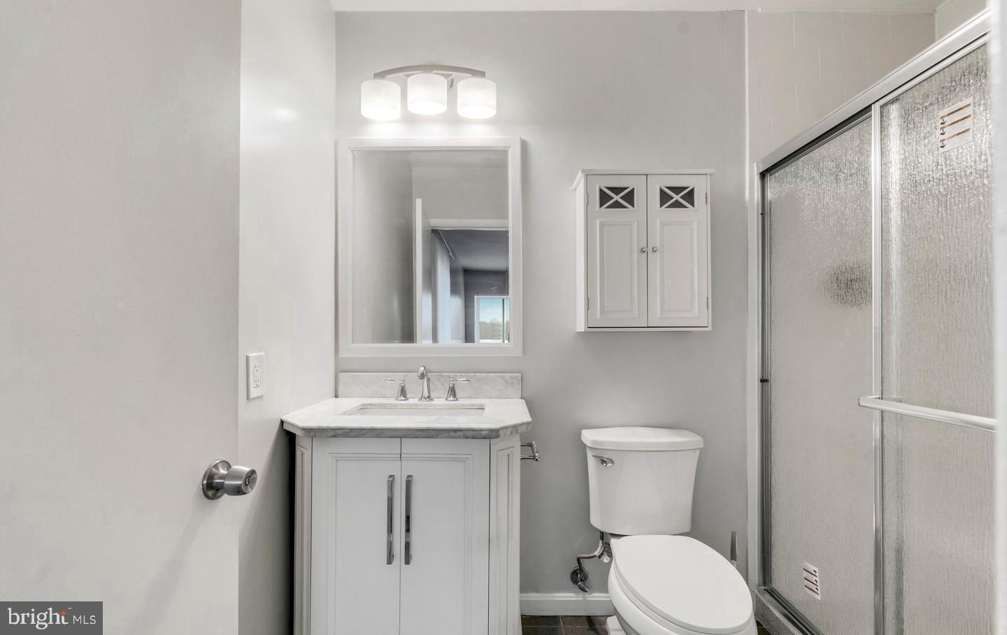 33 Stonehenge Circle, Unit 11 Baltimore, MD 21208 - Photo 14 of 22 a bathroom with a toilet sink and mirror