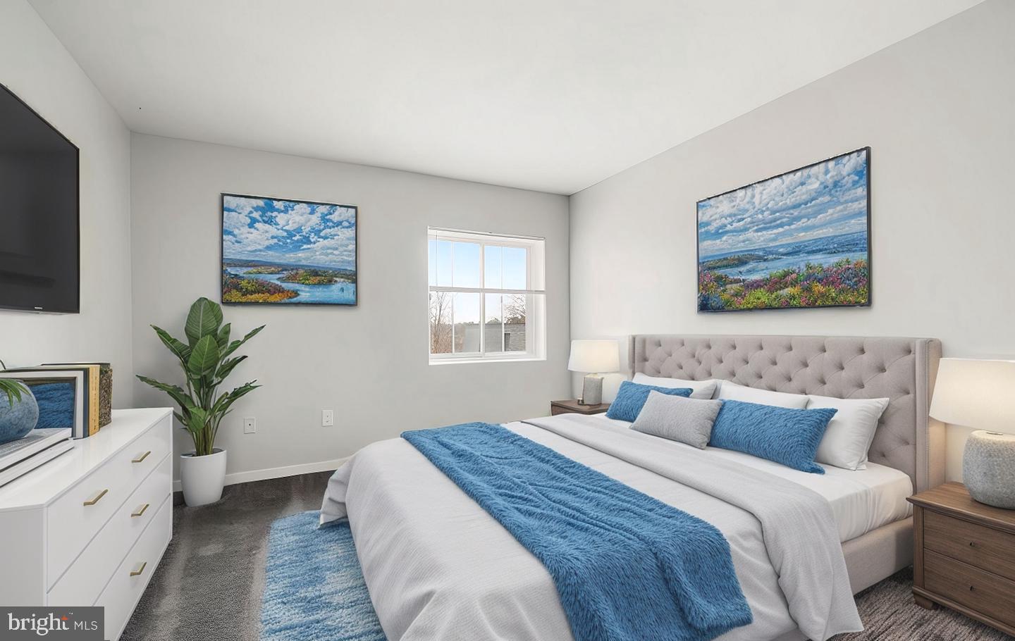 33 Stonehenge Circle, Unit 11 Baltimore, MD 21208 - Photo 15 of 22 a bedroom with bed and paintings on the wall