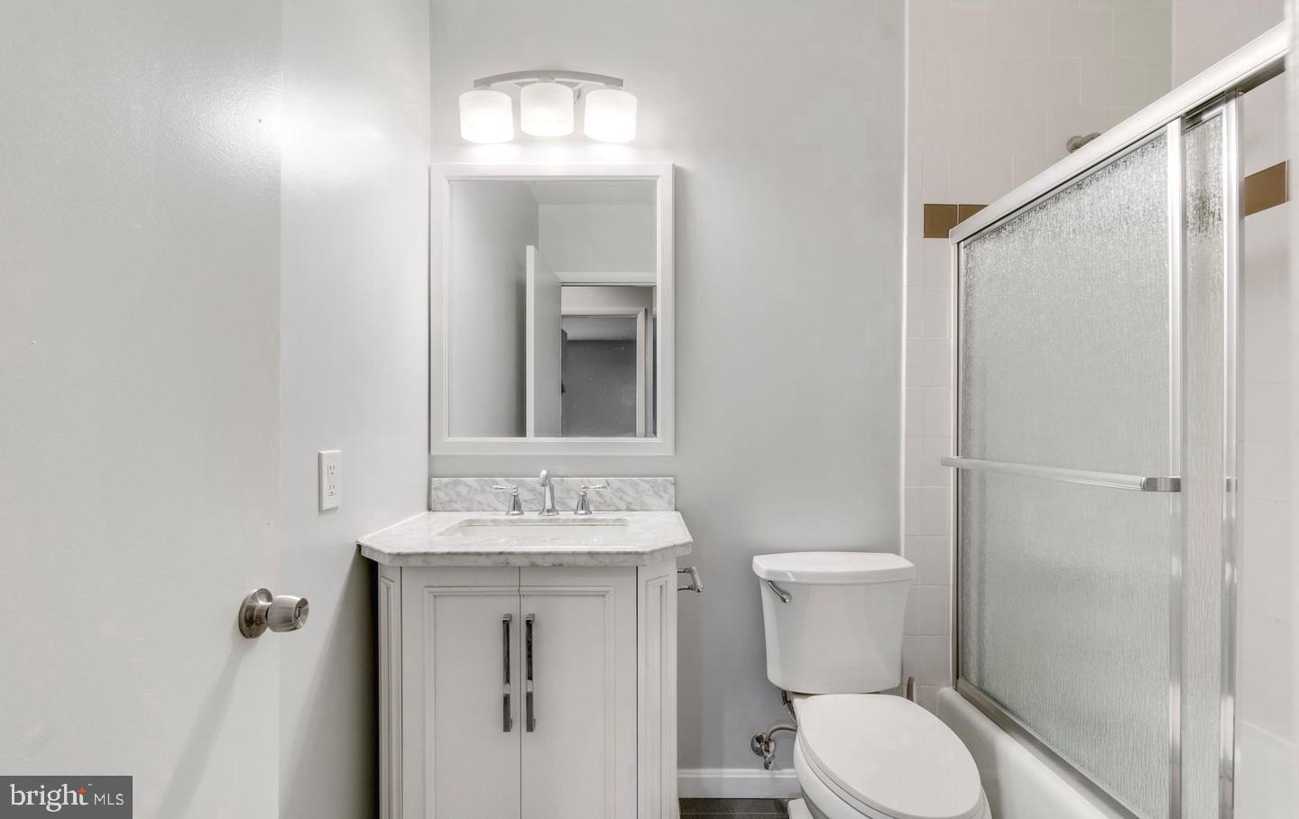 33 Stonehenge Circle, Unit 11 Baltimore, MD 21208 - Photo 16 of 22 a bathroom with a toilet sink and mirror