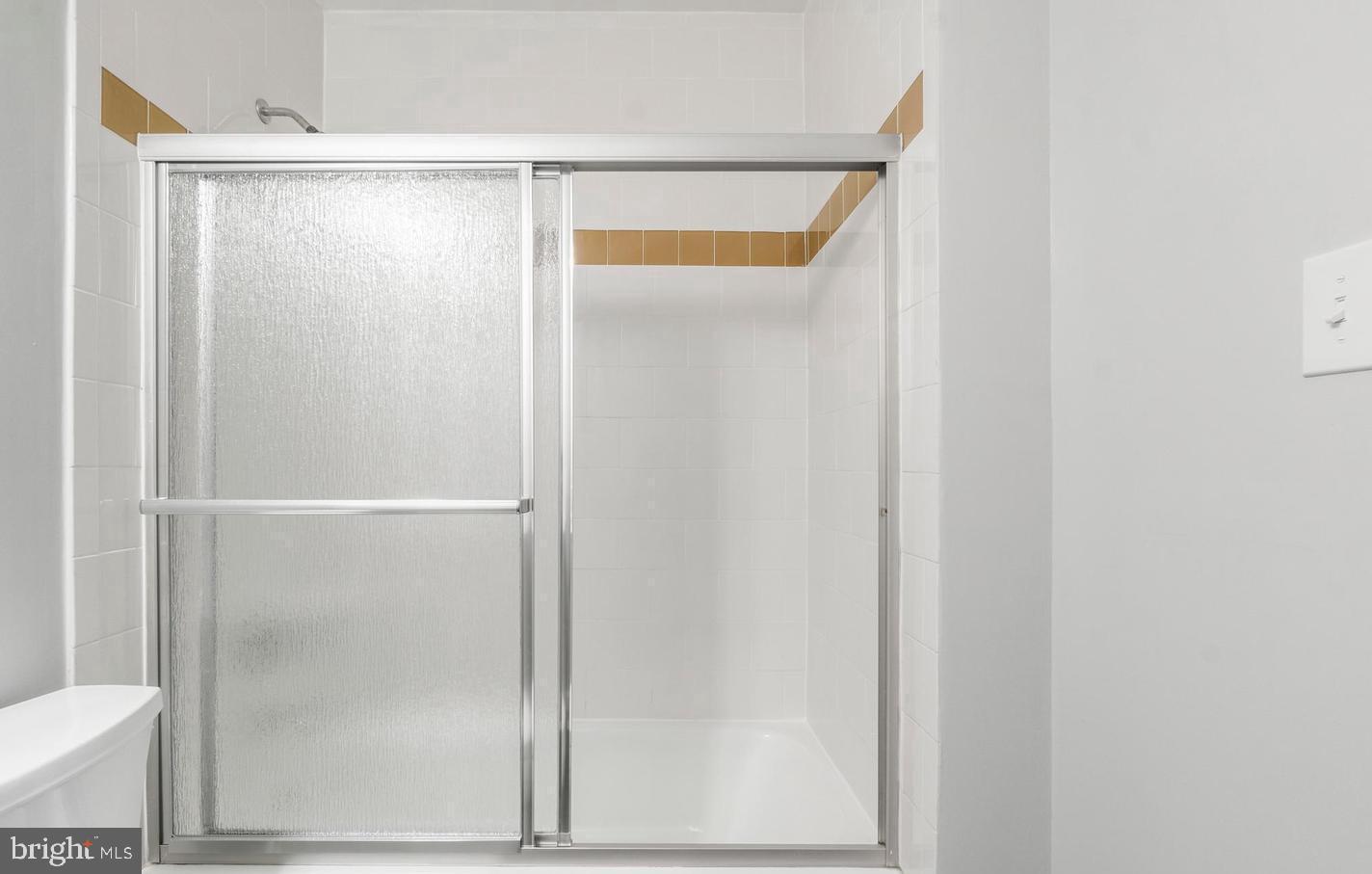 33 Stonehenge Circle, Unit 11 Baltimore, MD 21208 - Photo 17 of 22 a bathroom with a glass shower door