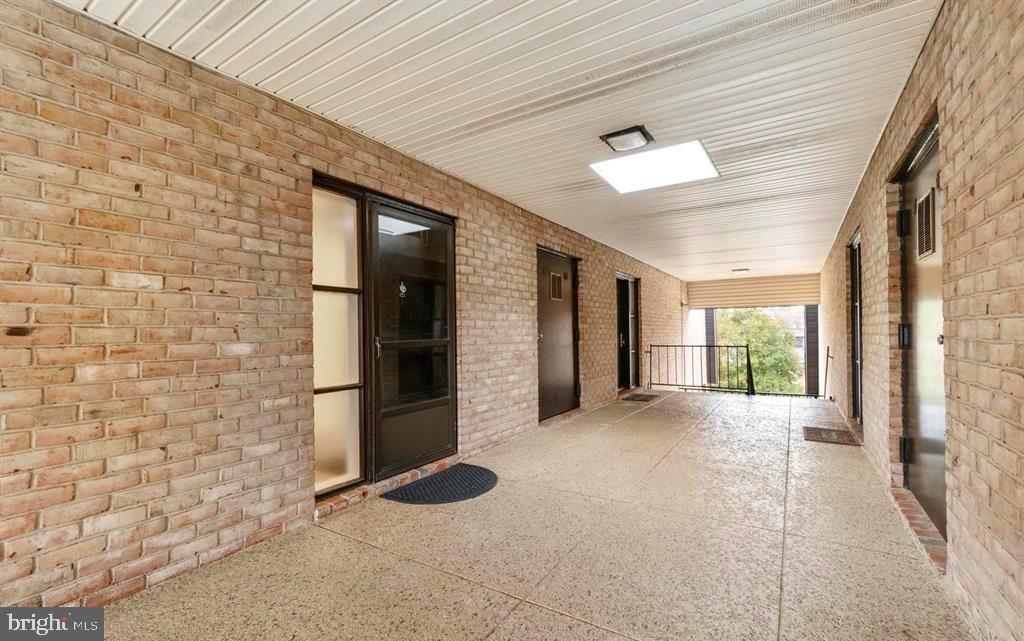 33 Stonehenge Circle, Unit 11 Baltimore, MD 21208 - Photo 3 of 22 a view of a hallway with windows