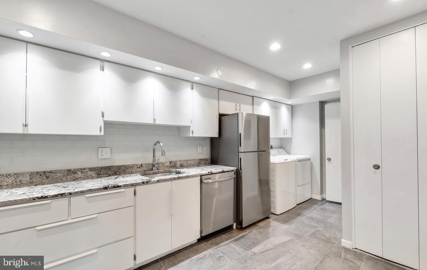 33 Stonehenge Circle, Unit 11 Baltimore, MD 21208 - Photo 9 of 22 a kitchen with a refrigerator sink and cabinets