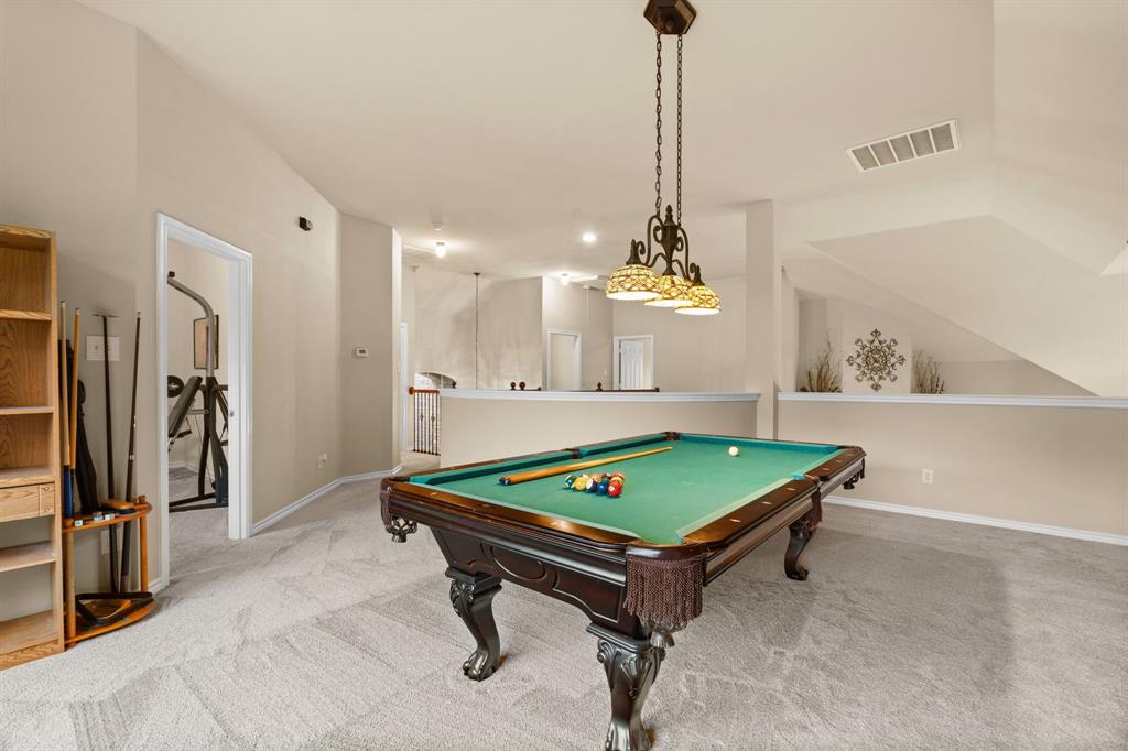 2703 Pottery Trail Corinth, TX 76210 - Photo 23 of 40 a room with pool table and a chandelier