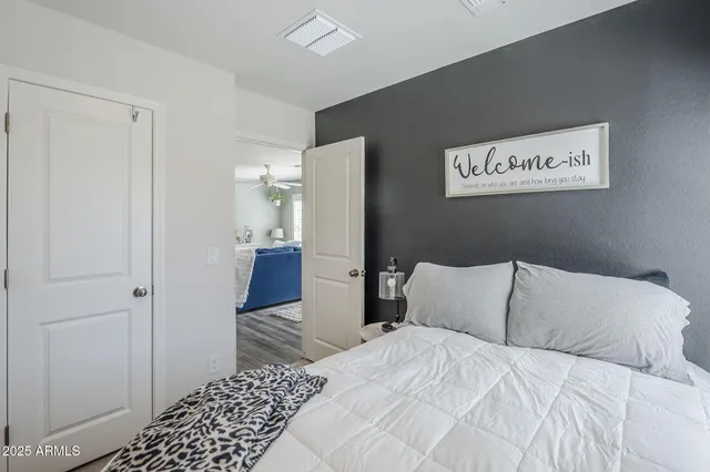 a bedroom with a bed and wooden floor