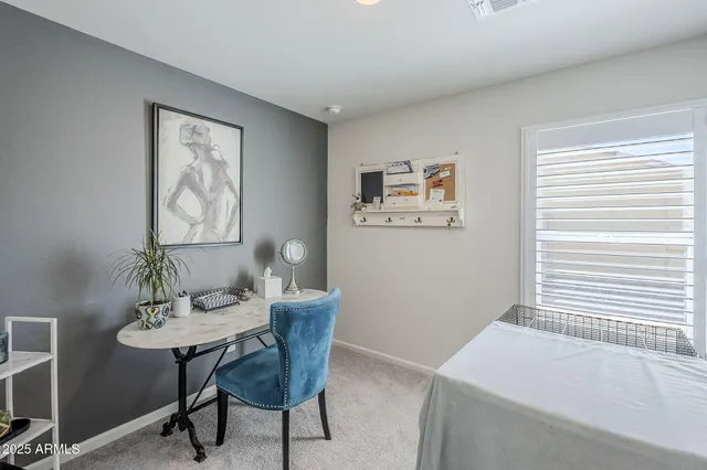 a view of a room with a table and chairs