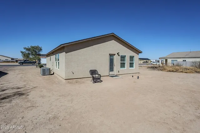 a view of a house with backyard and road