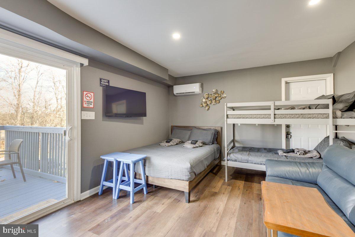 6604 Oak Street Cheverly, MD 20785 - Photo 11 of 16 a bedroom with a bed and large windows