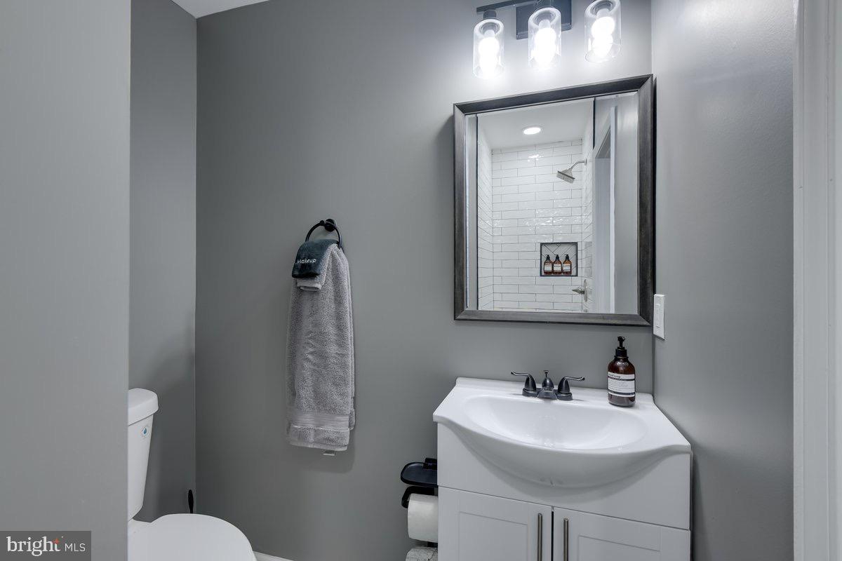 6604 Oak Street Cheverly, MD 20785 - Photo 13 of 16 a bathroom with a toilet sink and mirror