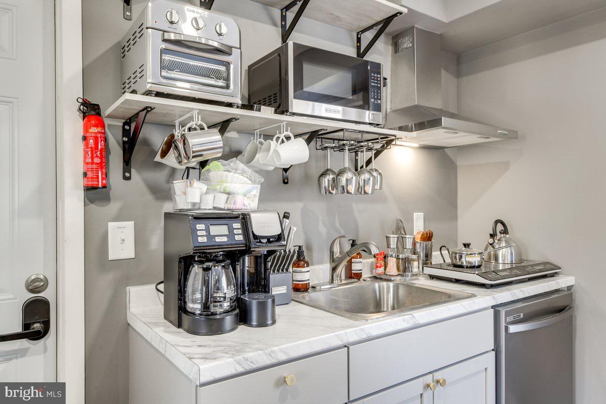 6604 Oak Street Cheverly, MD 20785 - Photo 4 of 16 a kitchen with stainless steel appliances granite countertop a sink and cabinets