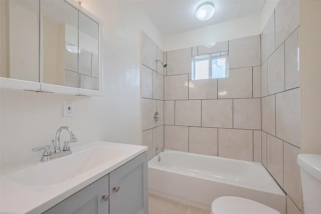 a bathroom with a sink a toilet and bathtub