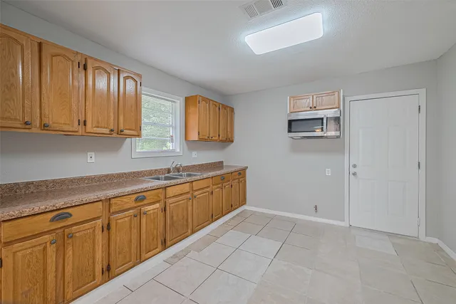 a kitchen with cabinets and window