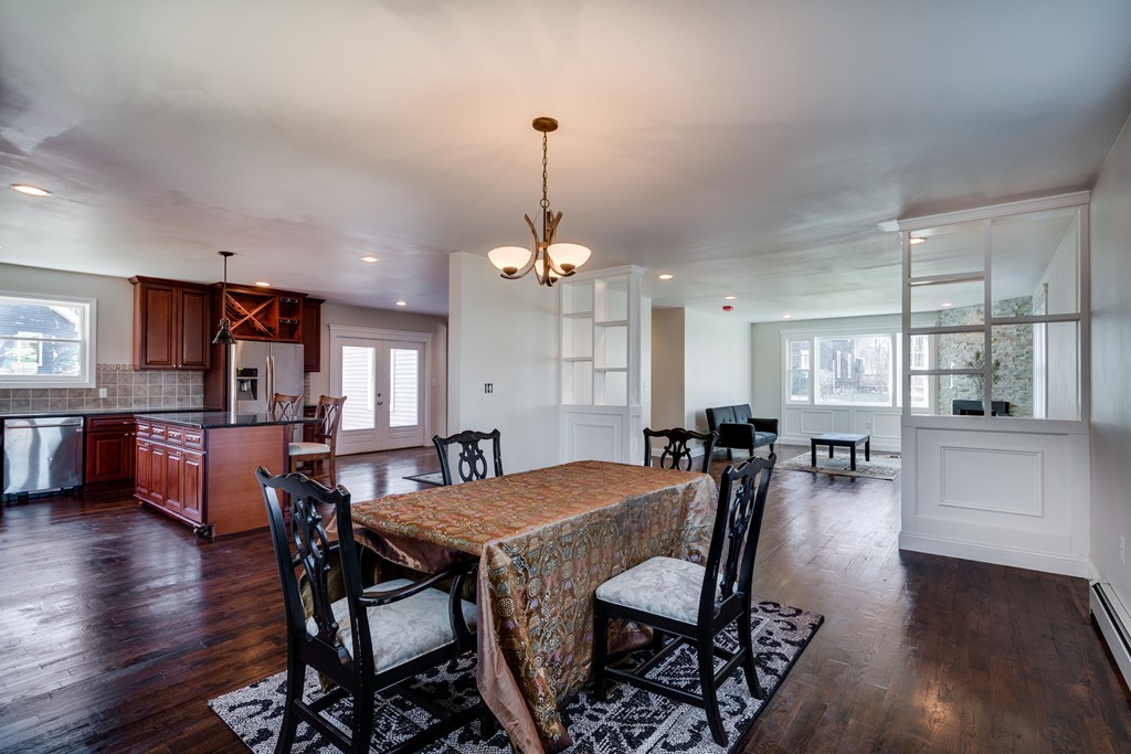 10 Felch Road Natick, MA 01760 - Photo 12 of 27 a view of a dining room and livingroom with furniture wooden floor a chandelier