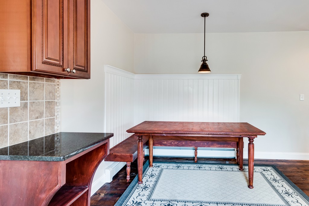10 Felch Road Natick, MA 01760 - Photo 16 of 27 a hallway with a table and a lamp with wooden floor