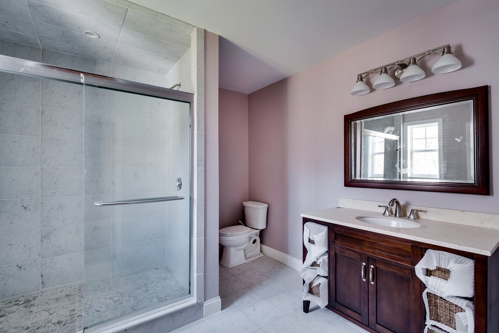 10 Felch Road Natick, MA 01760 - Photo 20 of 27 a bathroom with a sink vanity mirror and toilet