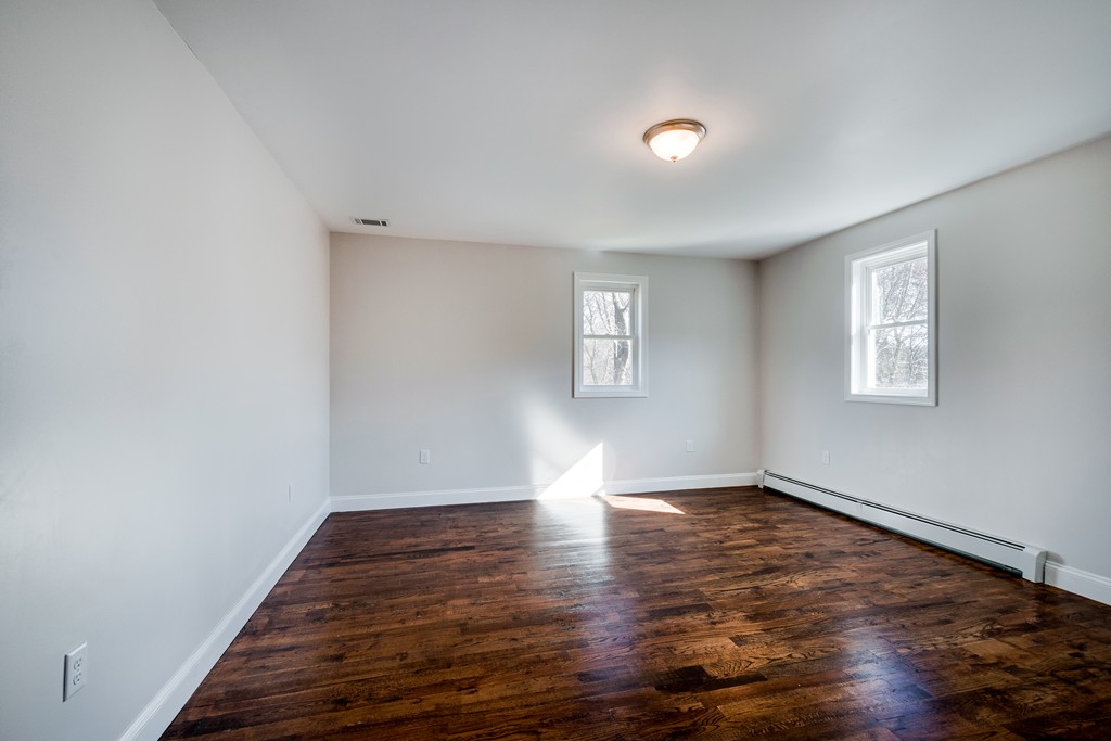 10 Felch Road Natick, MA 01760 - Photo 22 of 27 a view of wooden floor and windows in a room