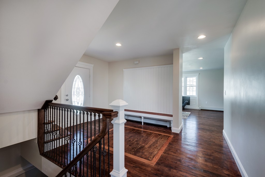 10 Felch Road Natick, MA 01760 - Photo 4 of 27 a view of a hallway with wooden floor and stairs