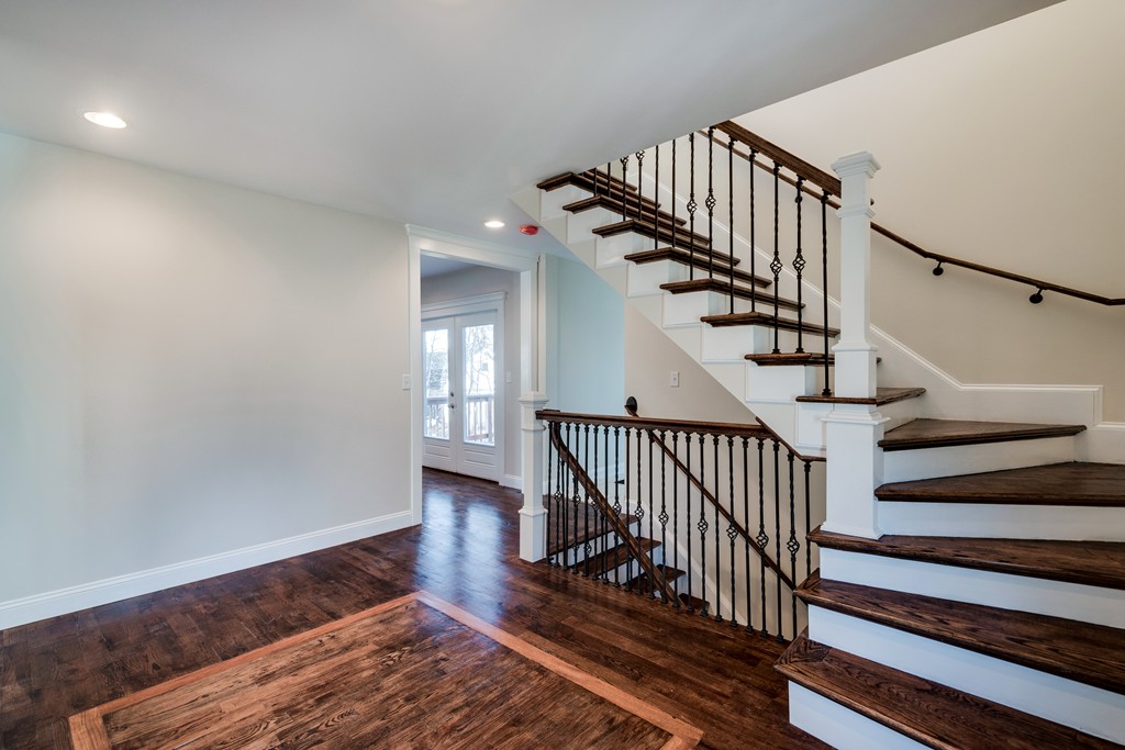 10 Felch Road Natick, MA 01760 - Photo 5 of 27 a view of staircase with wooden floor and white walls