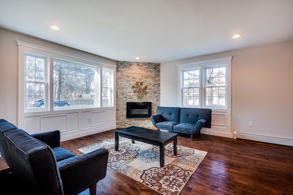 10 Felch Road Natick, MA 01760 - Photo 7 of 27 a living room with furniture and a fireplace