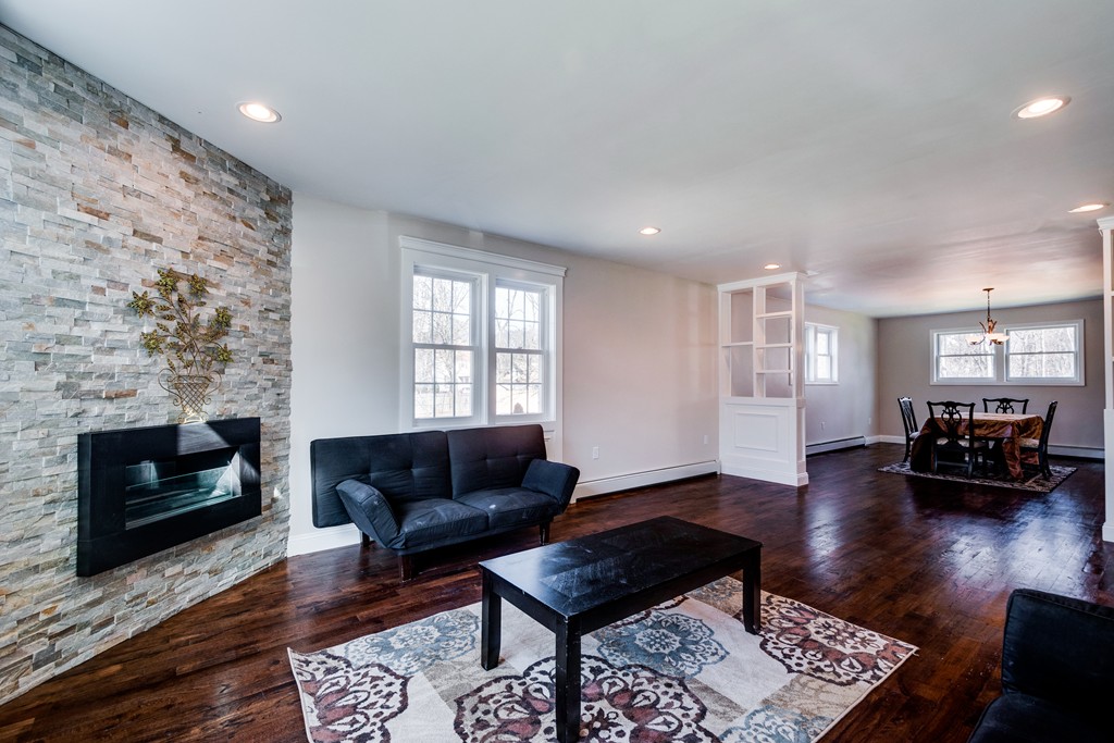10 Felch Road Natick, MA 01760 - Photo 9 of 27 a living room with furniture and a fireplace