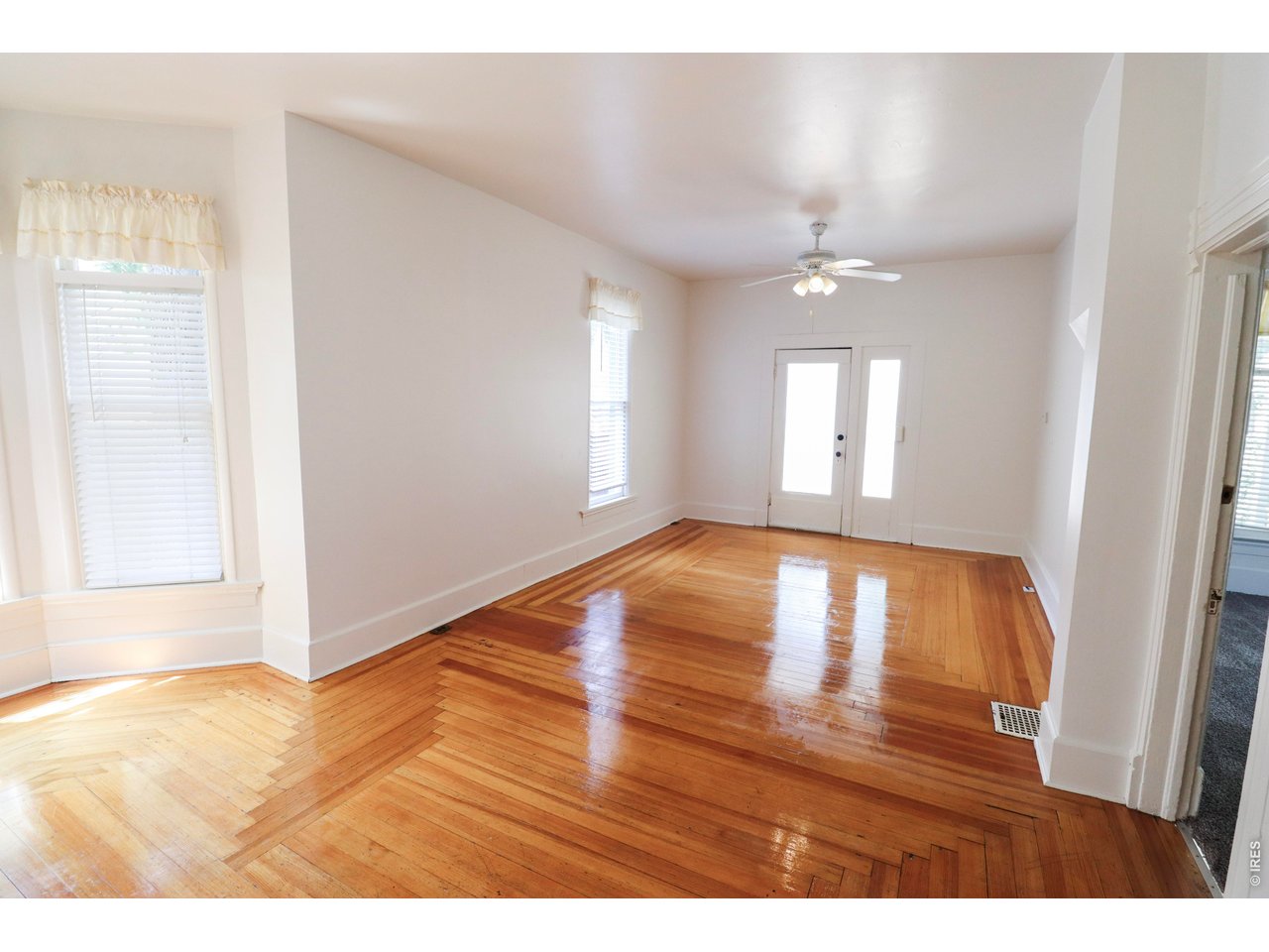608 South Howes Street Fort Collins, CO 80521 - Photo 6 of 28 a view of empty room with wooden floor and fan