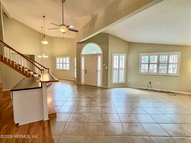 a view of a room with lots of windows and wooden floor
