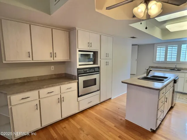a kitchen with granite countertop a sink and a stove top oven