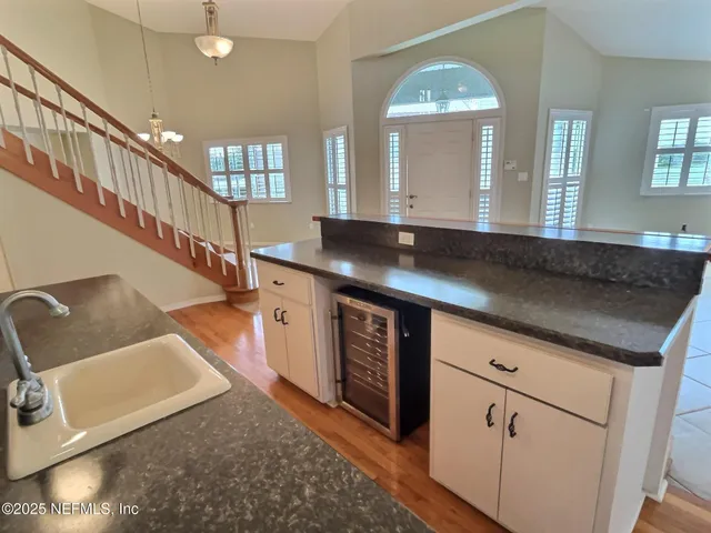 a kitchen with sink and mirror