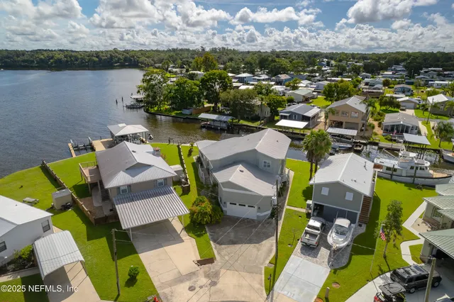 an aerial view of a house swimming pool and outdoor seating