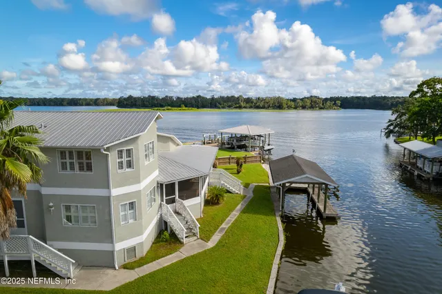 a view of a lake with a house in the background
