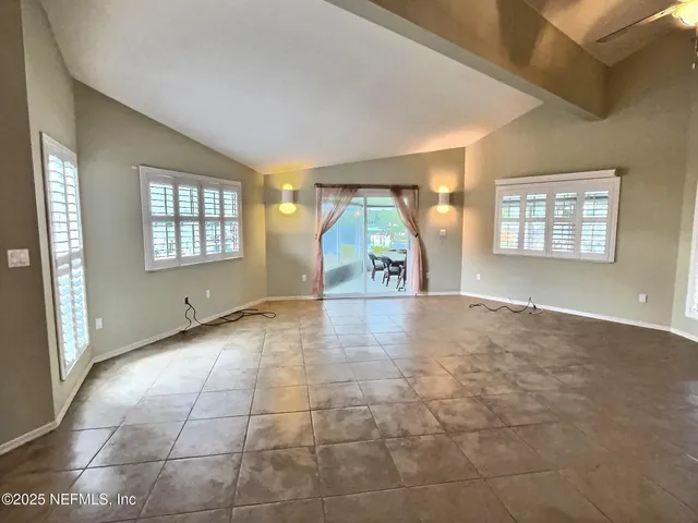 an empty room with windows and entrance