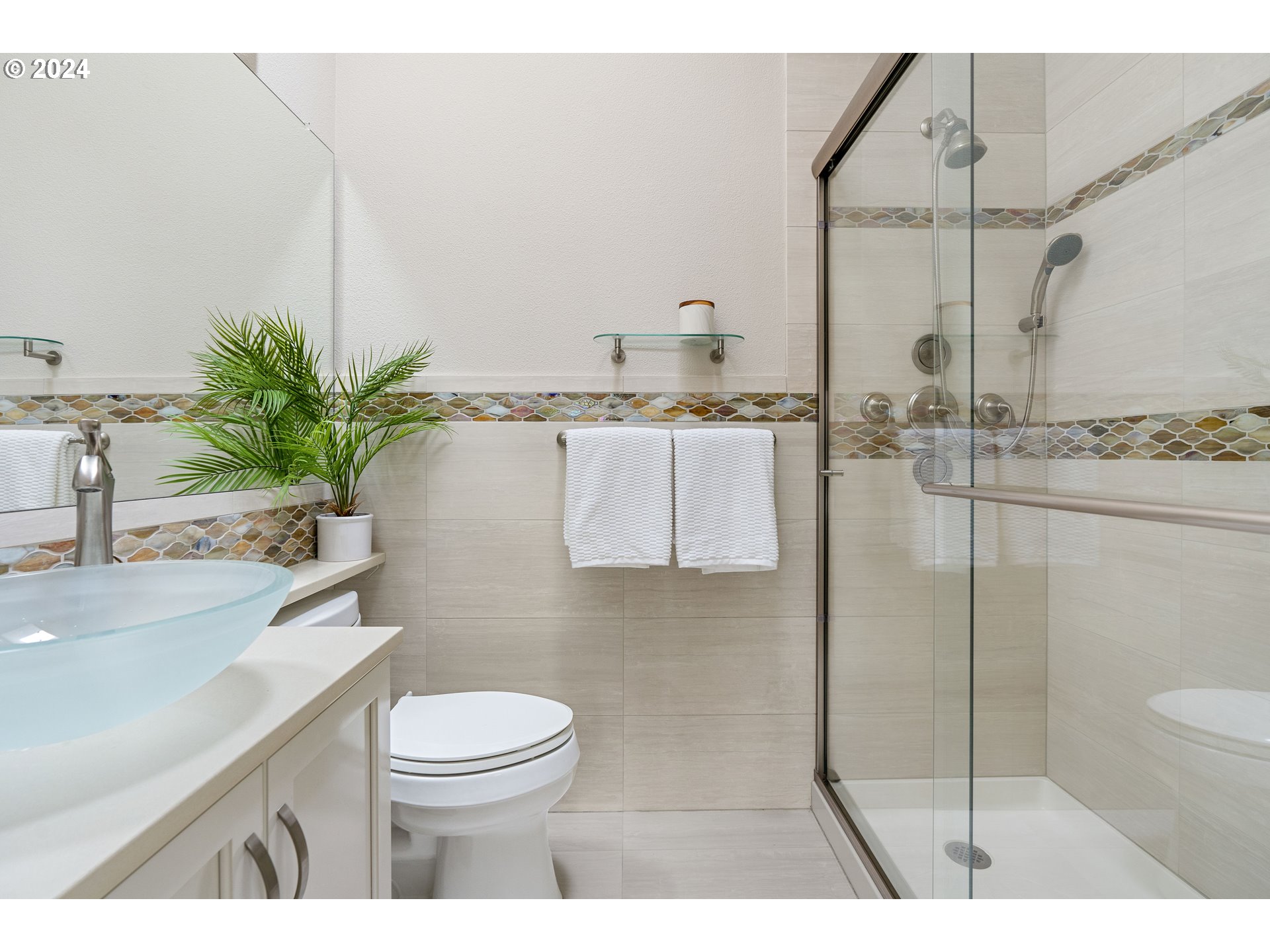 3531 South Kelly Avenue Portland, OR 97239 - Photo 16 of 21 a bathroom with a granite countertop sink a toilet a mirror and shower