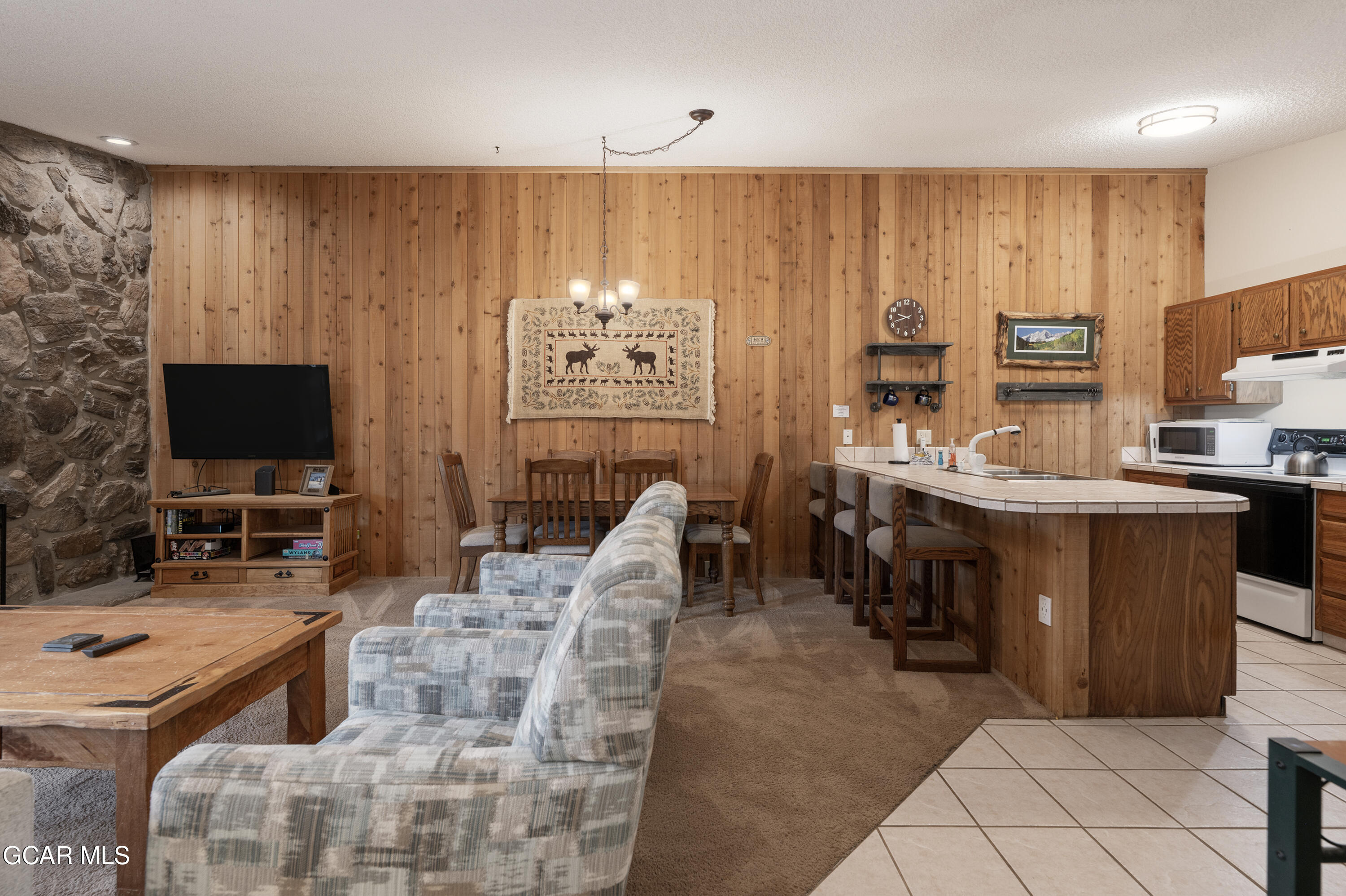 490 Kings Crossing Road, Unit 331 Winter Park, CO 80482 - Photo 3 of 38 a living room with furniture a flat screen tv and a view of kitchen