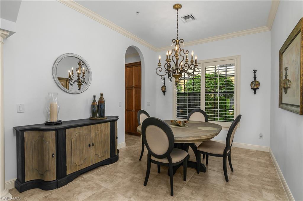 9109 Prima Way, Unit 102 Naples, FL 34113 - Photo 18 of 50 a dining room with furniture and window