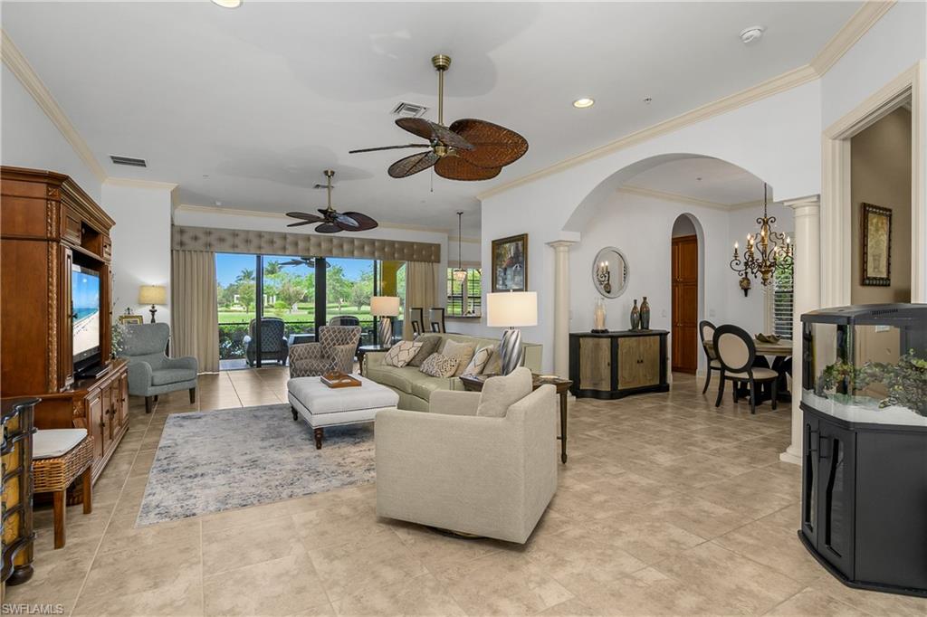 9109 Prima Way, Unit 102 Naples, FL 34113 - Photo 2 of 50 a living room with furniture a chandelier fan and a window