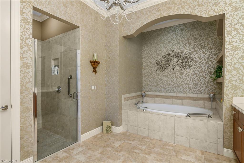 9109 Prima Way, Unit 102 Naples, FL 34113 - Photo 22 of 50 a bathroom with a shower and a bathtub