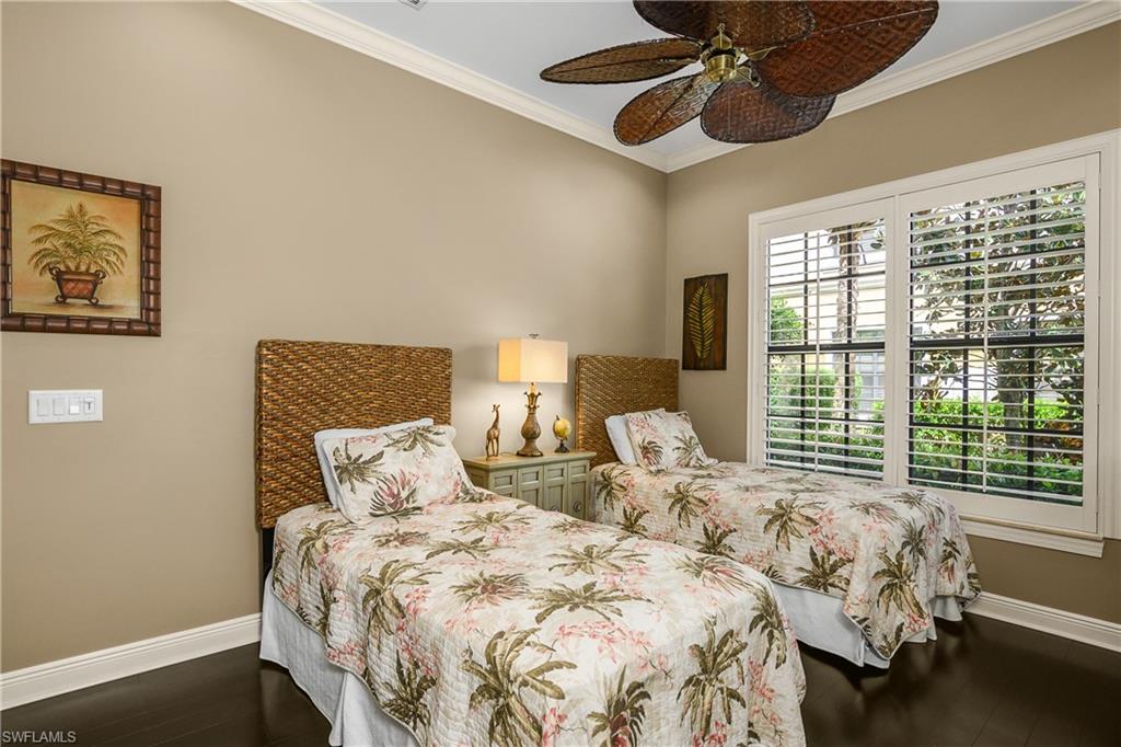 9109 Prima Way, Unit 102 Naples, FL 34113 - Photo 24 of 50 a bedroom with two beds and a large window