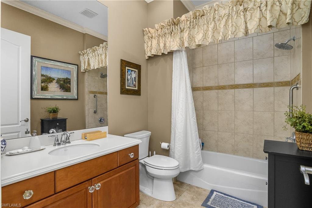 9109 Prima Way, Unit 102 Naples, FL 34113 - Photo 26 of 50 a bathroom with a sink a toilet and shower
