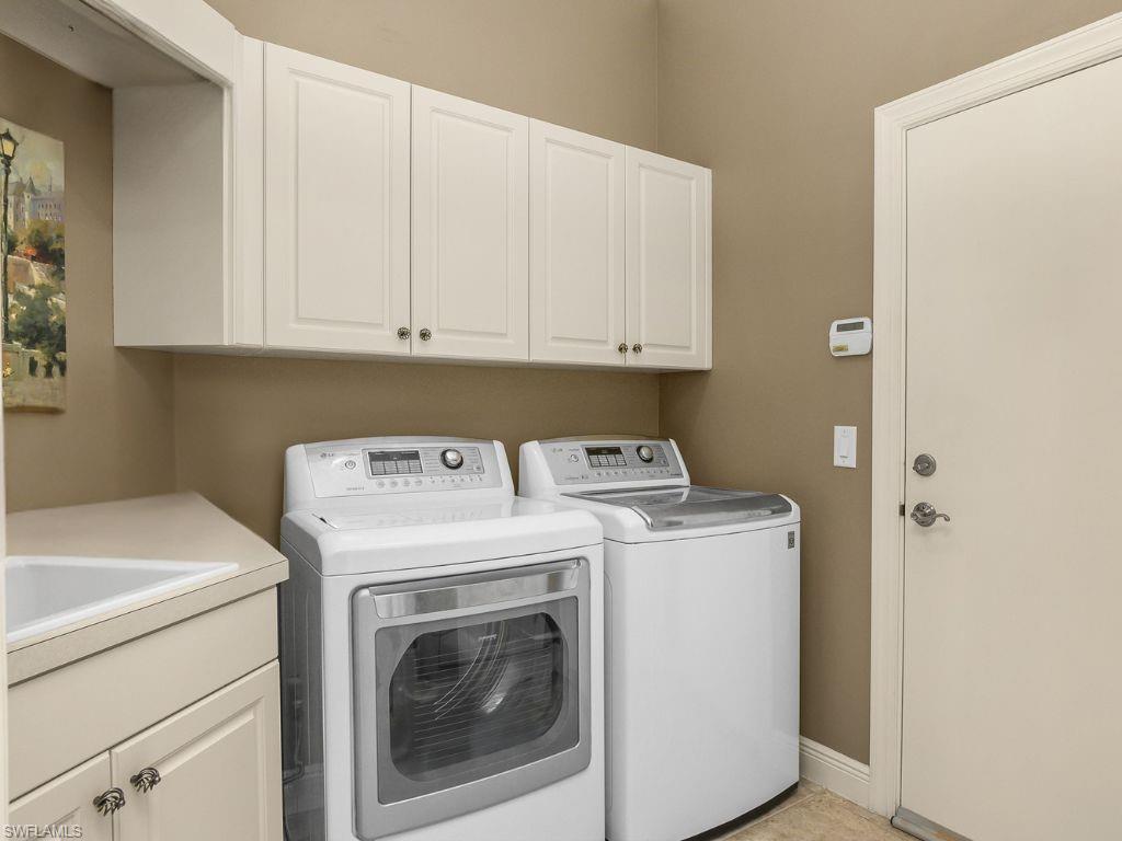 9109 Prima Way, Unit 102 Naples, FL 34113 - Photo 27 of 50 a utility room with dryer and washer
