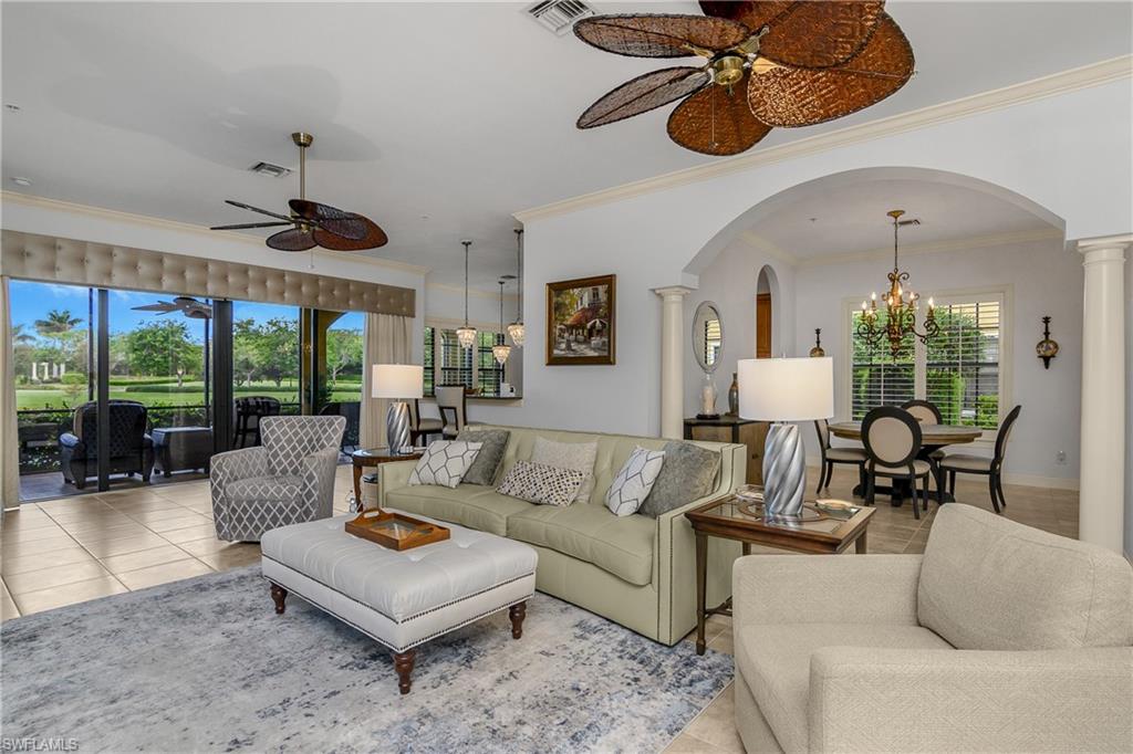 9109 Prima Way, Unit 102 Naples, FL 34113 - Photo 3 of 50 a living room with furniture ceiling fan and a large window