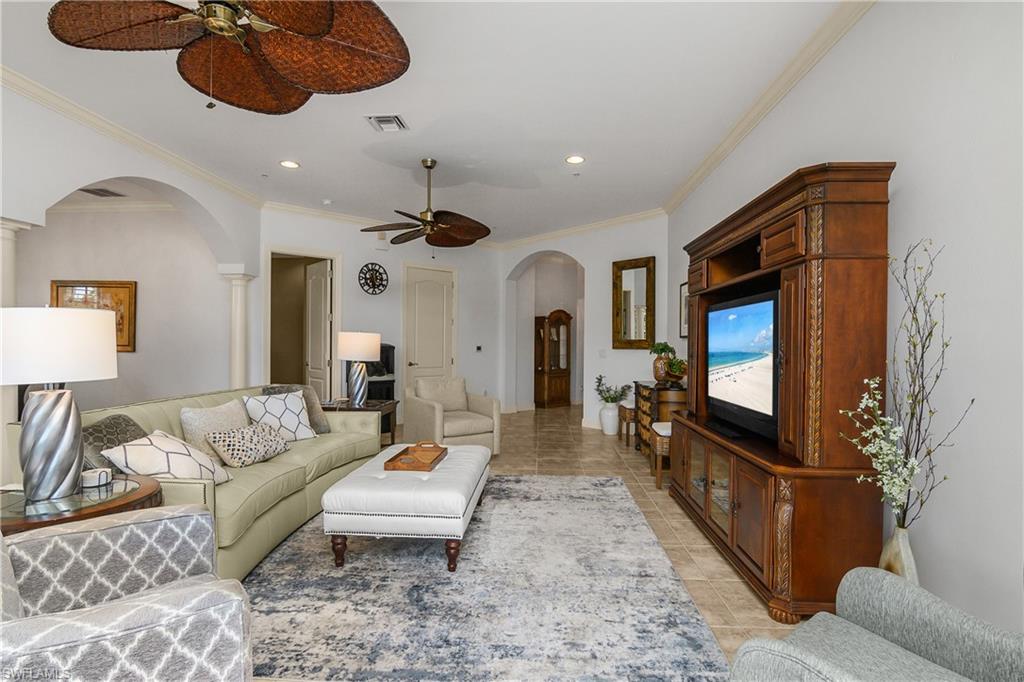 9109 Prima Way, Unit 102 Naples, FL 34113 - Photo 6 of 50 a living room with furniture a flat screen tv and a couch
