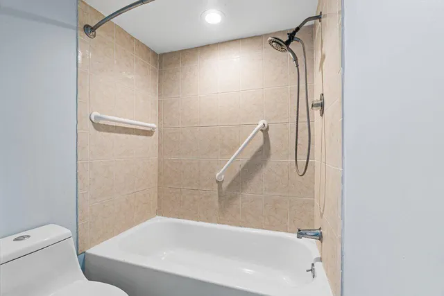 a bathroom with a bathtub and a shower