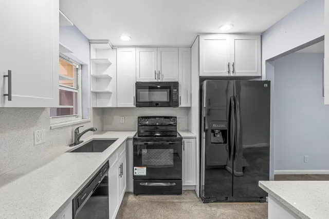 a kitchen with a refrigerator and a sink