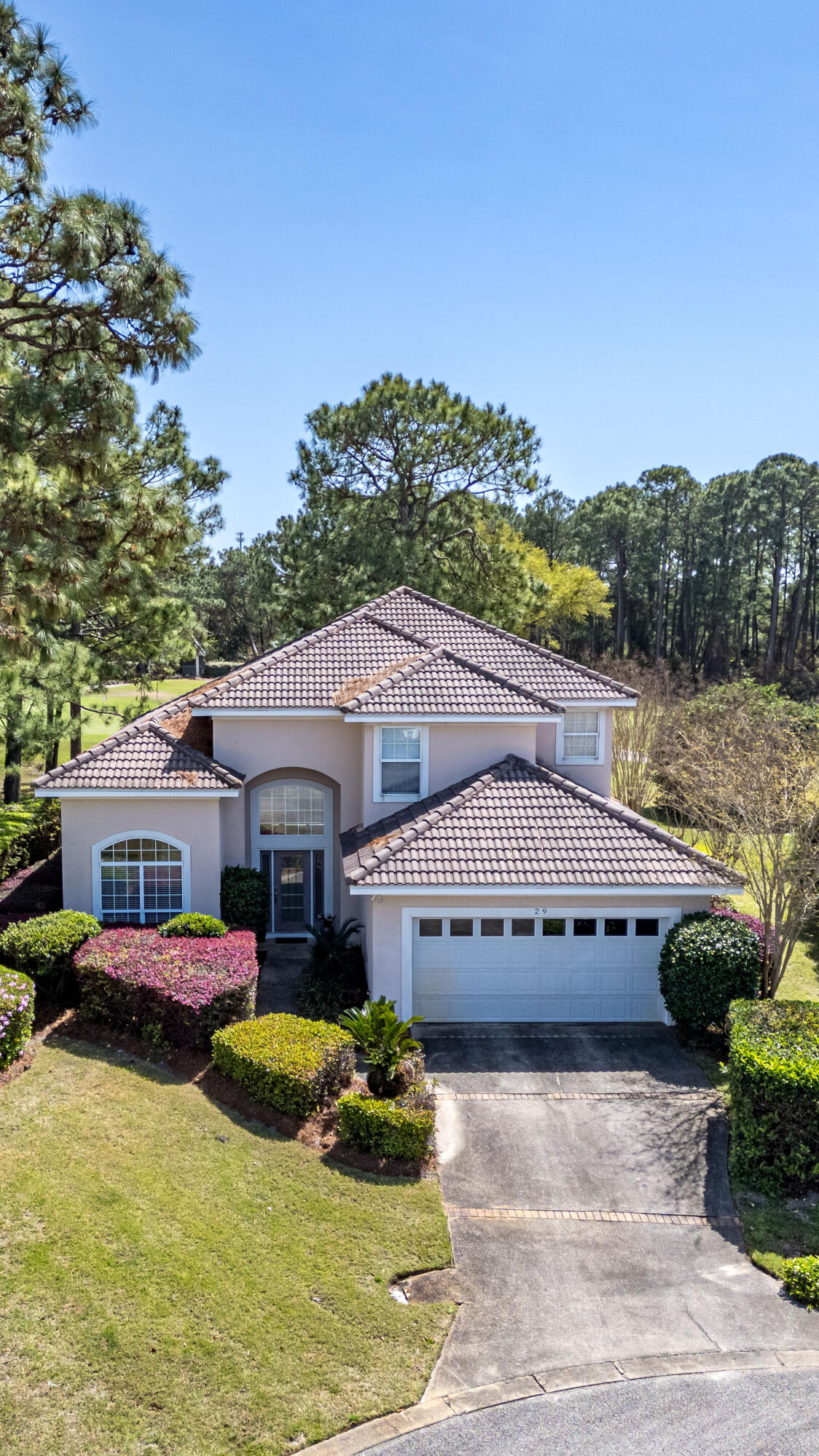 29 Ivory Court Miramar Beach, FL 32550 - Photo 24 of 39 a view of a white house with a yard plants and large tree