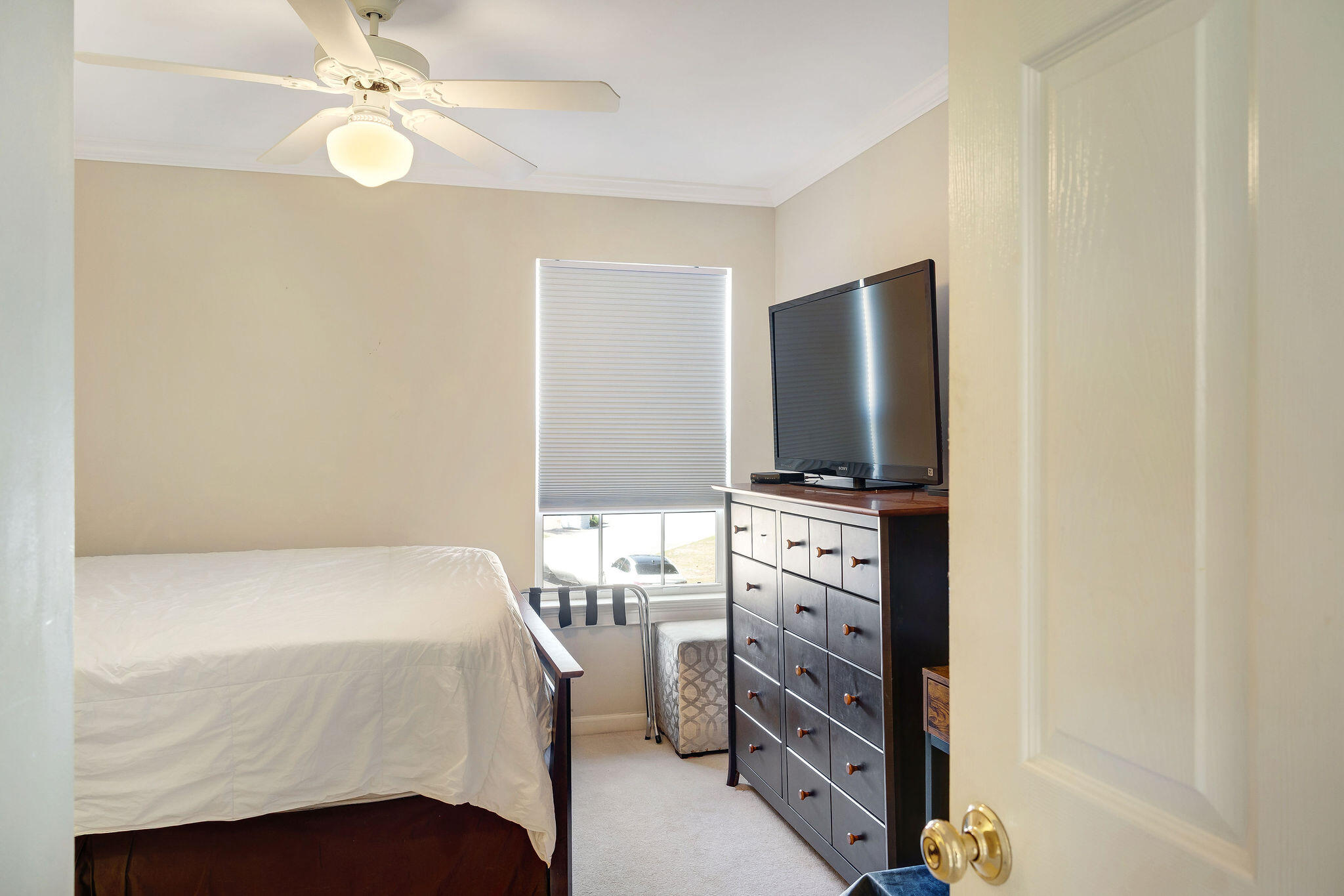 29 Ivory Court Miramar Beach, FL 32550 - Photo 35 of 39 a bedroom with a bed and a flat tv screen on dresser