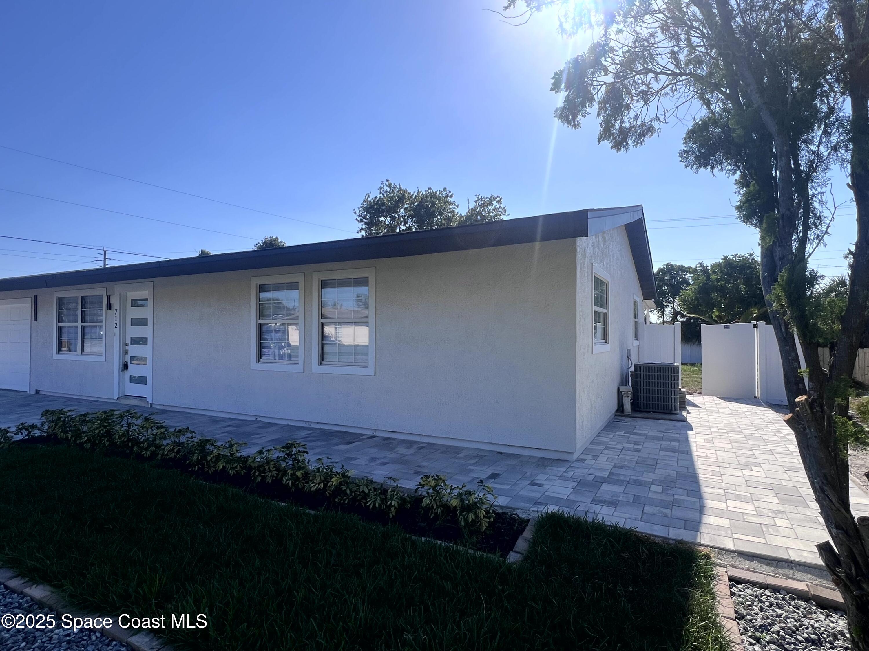712 Badger Drive Northeast Palm Bay, FL 32905 - Photo 1 of 26 a view of a house with backyard and garden
