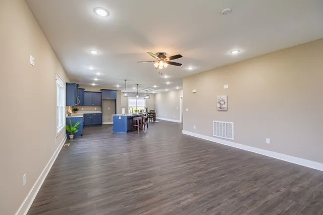 a kitchen with kitchen island a sink appliances and cabinets