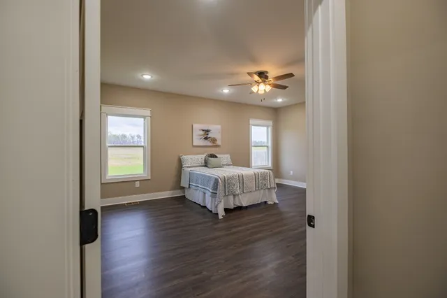 a bedroom with a bed and a ceiling fan
