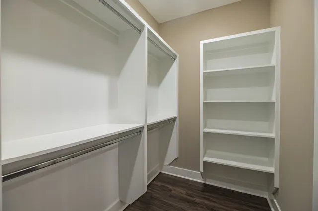 a spacious bedroom with a bed and a window